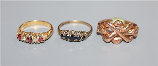 An Eastern yellow metal puzzle ring (tests as 14ct), an 18ct gold, ruby and diamond half-hoop ring and a sapphire half-hoop ring (3)